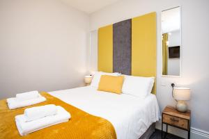 a bedroom with a bed with two towels on it at Stay Coastal in Whitley Bay