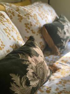 a bed with many pillows on top of it at Cross Haw Cottage in Sedbergh