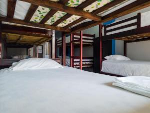 two beds in a room with two bunk beds at Hotel Sol y Playa Montañita in Montañita