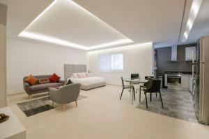 a living room with a couch and a table at Luxury one bedroom apartment - Best location in Rabat