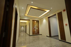 a hallway of a building with a mirror on the ceiling at The Grand Tree Hotel in Agra