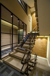 a set of stairs in a room with a brick wall at Kikar Boutique Hotel in Netanya