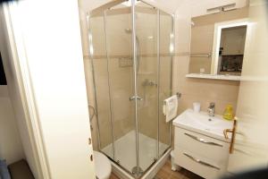 a bathroom with a shower and a toilet and a sink at Apartment Ljubica Tisno in Tisno +28 photos