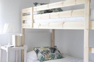 a bunk bed with a pillow on the bottom bunk at IseoLakeRental - Casa Rododendro in Sulzano
