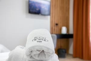 a white towel sitting on top of a bed at Buongiorno B&B Hotel in Marcos Juárez +56 photos