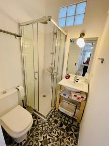 a bathroom with a shower and a toilet and a sink at Salty Home’s in Peniche +16 photos
