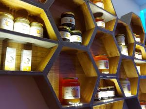 a shelf filled with lots of bottles of honey at Stallerhof in Hüttschlag