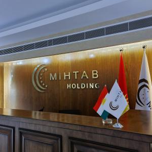 a sign for a hotel lobby with two flags at Dedeman Erbil Hotel City Center in Erbil