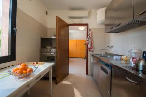a kitchen with a table with a bowl of fruit on it at Casa Battisti in Padova