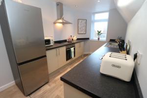 a kitchen with a counter with a toaster on top of it at The Snug in Stockton-on-Tees