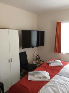 a hotel room with a bed and a television at Residence AlpenHeart in Bad Gastein