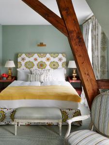 a bedroom with a large bed and two chairs at Château Gütsch in Luzern