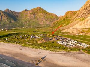 an aerial view of a parking lot next to a mountain at Lofoten Beach Camp in Ramberg