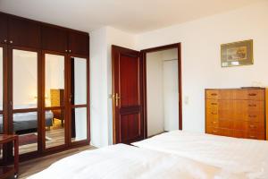 a bedroom with a bed and a dresser and a mirror at Hotel Bürgerhof Wetzlar in Wetzlar +45 photos
