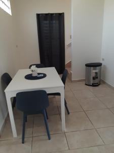 a white table and chairs in a room at Ulala Culebra in Culebra