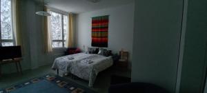 a bedroom with a bed and a painting on the wall at B&B Aittoranta in Puolanka +12 photos
