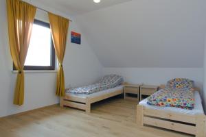 a room with two beds and a window at Domki ALEX in Swarzewo