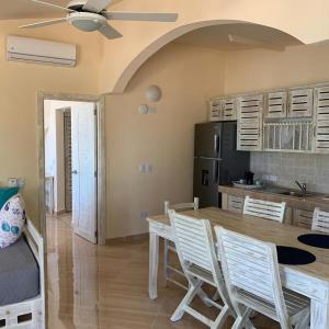 a kitchen and dining room with a table and chairs at guest house MY WAY in Las Terrenas