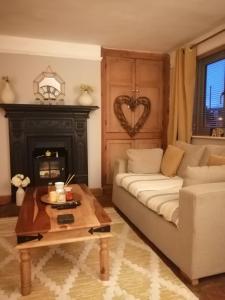 a living room with a couch and a table at Church cottage in Lincolnshire