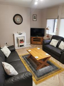 a living room with a couch and a coffee table at Angus House, 2 Bedroom House, Thurso, NC500 Route in Thurso