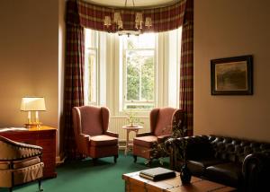 a living room with a couch and two chairs and a window at Marine North Berwick in North Berwick