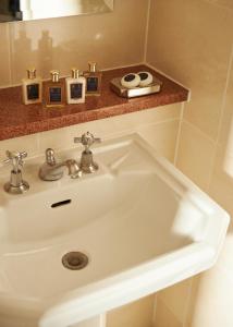 a white sink in a bathroom with a mirror at Marine North Berwick in North Berwick