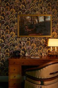 a painting on a wall with a desk and a chair at Marine North Berwick in North Berwick