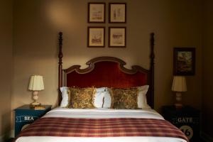 a bed with a wooden headboard and pillows on it at Marine North Berwick in North Berwick