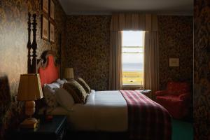 a bedroom with a bed and a window with a view at Marine North Berwick in North Berwick