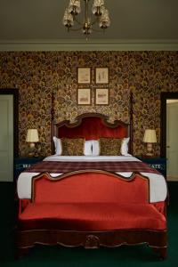 a bedroom with a large bed with a red bench at Marine North Berwick in North Berwick