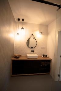 a bathroom with a sink and a mirror at Dom na Cuplu in Serock