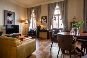 a living room with a couch and a table at Boutique Hotel Nautilus in Tábor