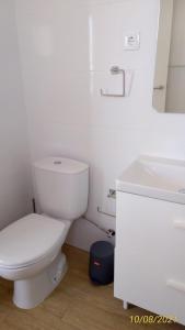 een witte badkamer met een toilet en een wastafel bij Sol e Praia Alvor 2 in Alvor