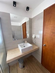 a bathroom with a sink and a mirror at Fincas del Real in Colonia del Sacramento