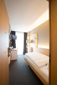 Giường trong phòng chung tại Best Western Plus Hotel Zürcherhof
