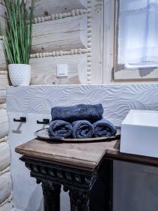 a plate of towels on a table in a bathroom at Koniakowo - dom Forest in Koniaków