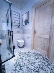 a bathroom with a shower and a toilet and a door at Koniakowo - dom Forest in Koniaków +23 photos