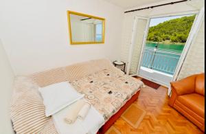 a living room with a couch and a large window at Apartment Niksa in Novigrad Dalmatia