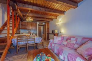 a living room with a couch and a table at Appartamento Adèle- CIR 0063 in La Thuile