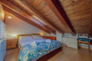 a bedroom with a bed and a wooden ceiling at Appartamento Adèle- CIR 0063 in La Thuile