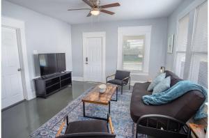 a living room with a couch and a tv at Wonderful 3 BR 2 BA Near Downtown in San Antonio