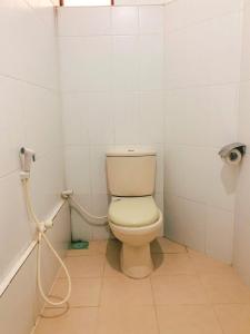 a bathroom with a white toilet in a stall at Pawana Rest in Dambulla