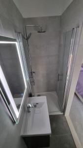 a bathroom with a shower and a sink and a shower at Room Airport Split in Kaštela
