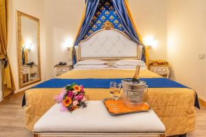 a hotel room with a bed with a bottle of champagne and flowers at Hotel Porta Faenza in Florence