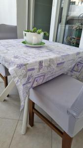 a table with a bowl of vegetables on top of it at Room Airport Split in Kaštela