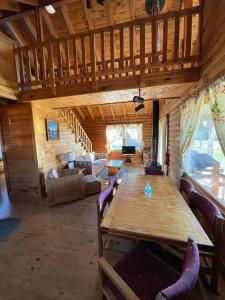 a living room with a large wooden table in a cabin at Unity Sky Lodge in Jackman