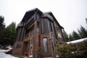 a house is shown in the snow at Green Zone in Migovo