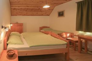 a bedroom with a bed and a desk at Farm Holidays Povsin in Bled