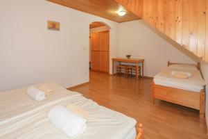 a bedroom with a bed and a dresser at Farm Holidays Povsin in Bled