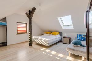 a bedroom with a bed and a tree in it at Apartamenty Pod Dębem in Wicie